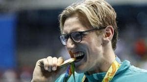 Australia's Mack Horton bites his gold medal on the podium of the Men's 400m Freestyle Final during the swimming event at the Rio 2016 Olympic Games at the Olympic Aquatics Stadium in Rio de Janeiro on August 6, 2016. / AFP / Odd ANDERSEN (Photo credit should read ODD ANDERSEN/AFP/Getty Images)