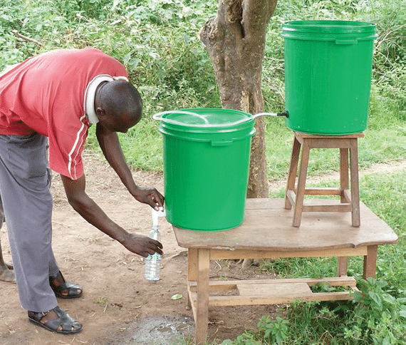 Water Works Charity Team Building Event - recipients using filtration system